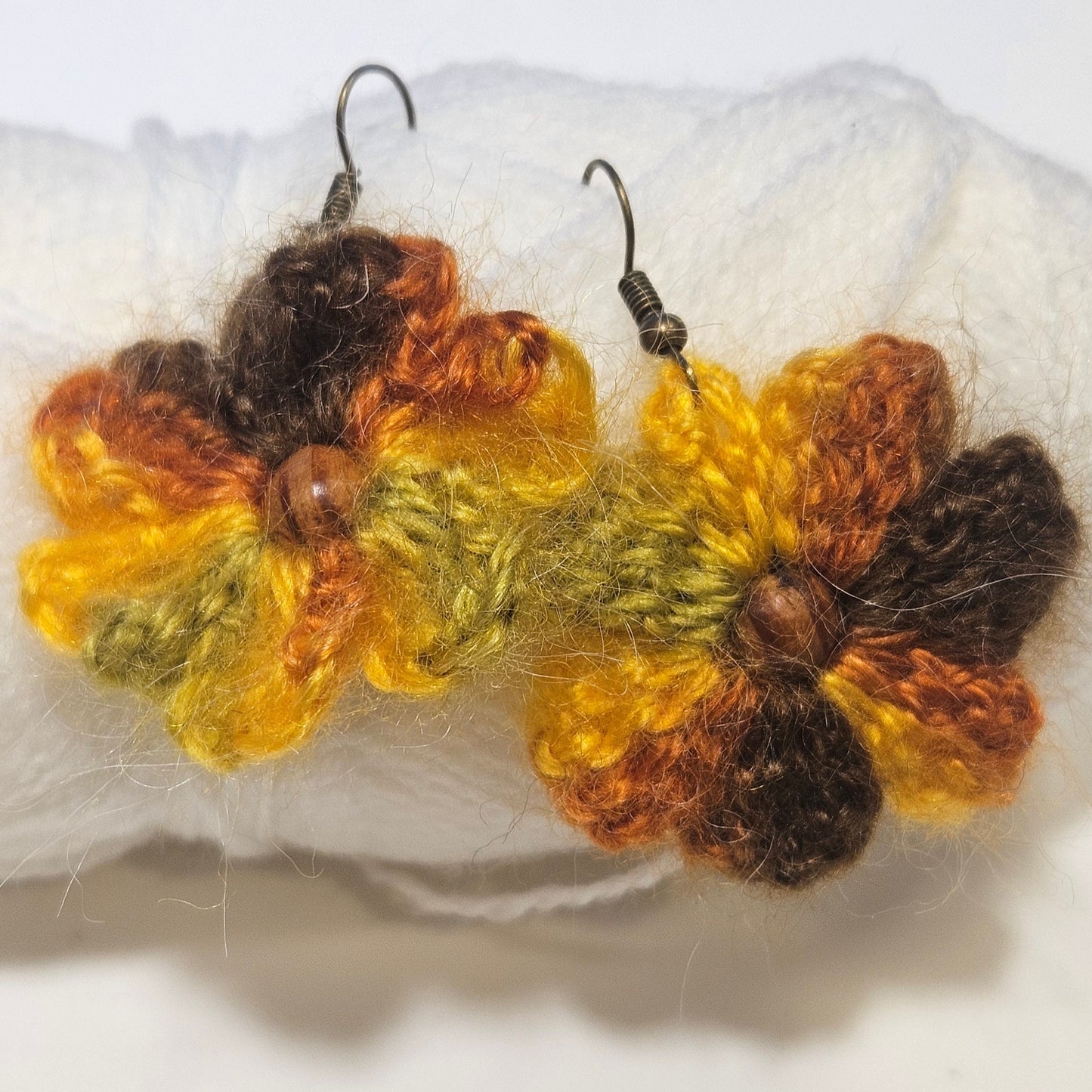 Pair of crocheted flower earrings on a white background