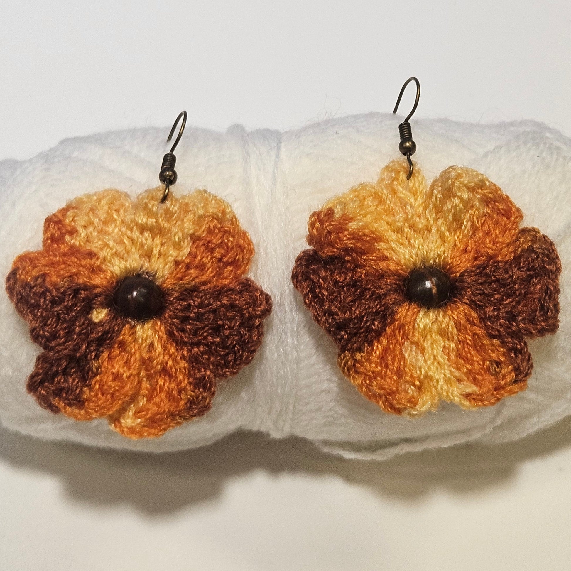 Pair of crochet flower earrings on a white background