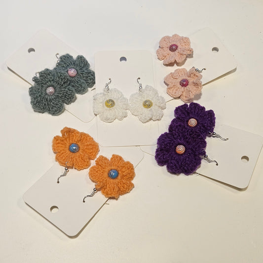 Set of colourful crochet flower earrings on display cards.