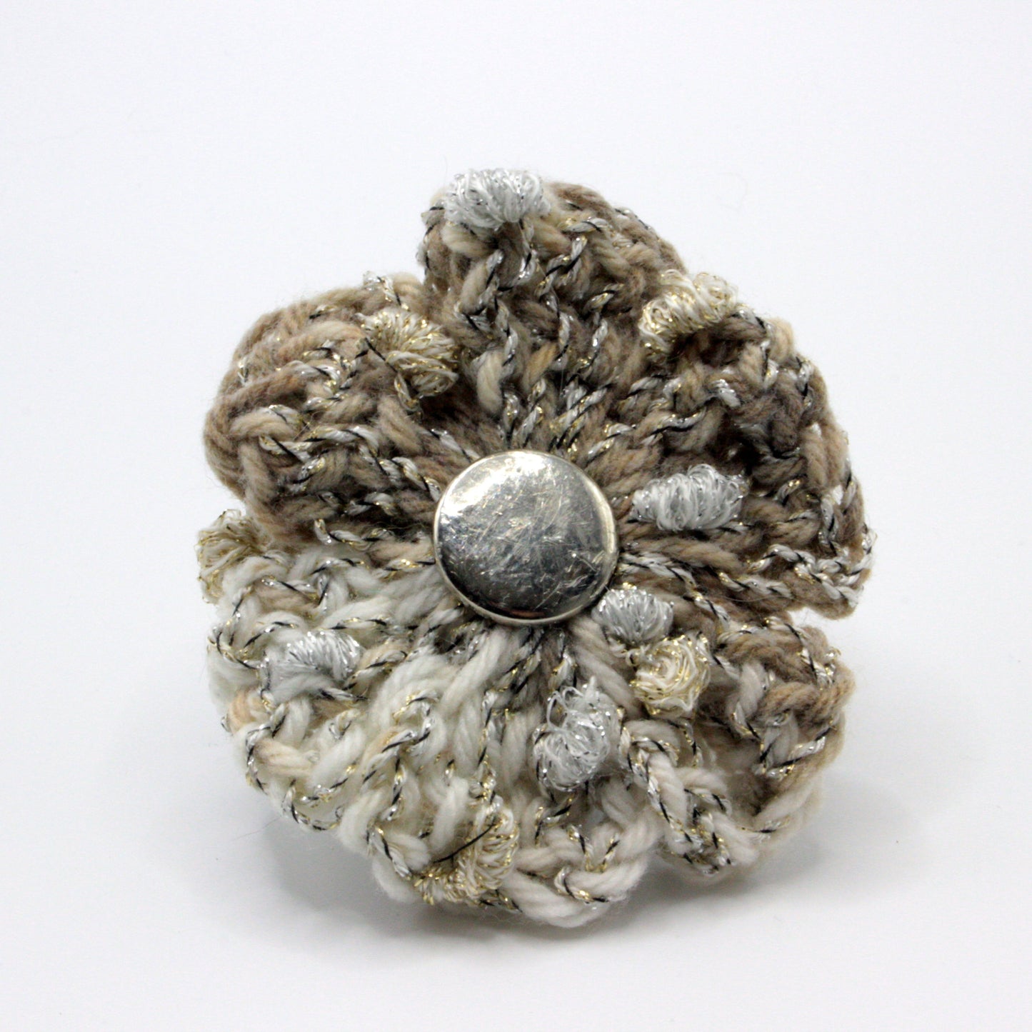 Crocheted flower with a button center on a white background